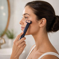 Gliding the LED eye massager along the under-eye area